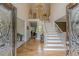 Grand foyer with hardwood floors, staircase, and chandelier, creating a welcoming entrance at 1180 Oxford Dr, Conyers, GA 30013