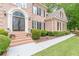 Charming front entrance with decorative glass doors and meticulously maintained landscaping at 1180 Oxford Dr, Conyers, GA 30013