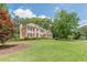 Beautiful two-story brick home with a well-manicured lawn and landscaped garden beds at 1180 Oxford Dr, Conyers, GA 30013
