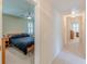 Hallway view into a bedroom with a ceiling fan and natural light coming through the plantation shutters at 1180 Oxford Dr, Conyers, GA 30013