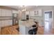 Modern kitchen with stainless steel appliances, white cabinetry, and a granite island with seating at 1180 Oxford Dr, Conyers, GA 30013