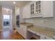 Bright kitchen featuring granite countertops, hardwood floors, and stainless steel appliances at 1180 Oxford Dr, Conyers, GA 30013