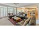 Bright living room featuring large windows, plush sofas, and seamless access to kitchen at 1180 Oxford Dr, Conyers, GA 30013