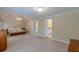 Spacious main bedroom featuring neutral carpet, tray ceilings, and en-suite bathroom access at 1180 Oxford Dr, Conyers, GA 30013
