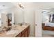 Bathroom featuring granite countertops, double sinks, wooden cabinets and an open door to a bedroom at 425 Hunt Ne St, Marietta, GA 30060