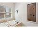 Bathroom featuring a garden tub with a window and a separate shower with a glass door at 425 Hunt Ne St, Marietta, GA 30060