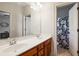 Bright bathroom featuring double sinks, a large mirror, and a floral shower curtain at 425 Hunt Ne St, Marietta, GA 30060