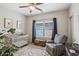 Cozy bedroom with a crib, glider, and a window with blue curtains at 425 Hunt Ne St, Marietta, GA 30060