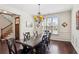 Elegant dining room with dark wood table, chandelier, wainscoting, and large window at 425 Hunt Ne St, Marietta, GA 30060