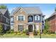 Charming two-story home featuring stone accents, blue siding, well-manicured landscaping and a welcoming entryway at 425 Hunt Ne St, Marietta, GA 30060