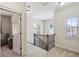 Upstairs hallway with a dark metal and wooden banister and lots of light at 425 Hunt Ne St, Marietta, GA 30060