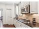 Charming kitchen featuring white cabinets, granite countertops, and a stainless steel microwave at 425 Hunt Ne St, Marietta, GA 30060