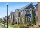View of a charming home with stone and blue siding along a well-landscaped street with sidewalk at 425 Hunt Ne St, Marietta, GA 30060