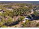 An aerial view reveals a charming home nestled among lush trees and greenery within a serene neighborhood at 5035 Villa Rica Hwy, Dallas, GA 30157