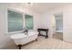 Bathroom featuring a claw foot bathtub, a window, and tile flooring at 5035 Villa Rica Hwy, Dallas, GA 30157