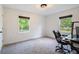Carpeted bedroom featuring two windows and a desk with a black office chair at 5035 Villa Rica Hwy, Dallas, GA 30157