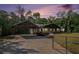 Long-shot exterior shot of the house with a covered carport, mature trees, and a gated entrance at 5035 Villa Rica Hwy, Dallas, GA 30157