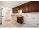 A laundry room with wooden cabinets, tile flooring, and a doorway to another room at 5035 Villa Rica Hwy, Dallas, GA 30157