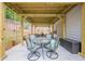 Outdoor covered patio with seating area including chairs and a round glass table at 549 Greenridge Ln, Loganville, GA 30052