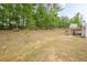Large grassy backyard, partially wooded, with plenty of space for outdoor activities and recreation at 549 Greenridge Ln, Loganville, GA 30052