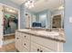 Bathroom featuring double sinks and ample storage in white cabinets with dark hardware at 549 Greenridge Ln, Loganville, GA 30052