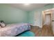 Cozy bedroom with light-green walls, wood floor and convenient access to the hallway at 549 Greenridge Ln, Loganville, GA 30052
