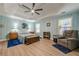Tranquil bedroom featuring a tray ceiling, ceiling fan, and blue accent wall at 549 Greenridge Ln, Loganville, GA 30052