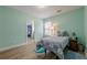 Bedroom features wood floor, light-green walls, single bed and ensuite bath for added convenience at 549 Greenridge Ln, Loganville, GA 30052