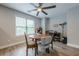 Bright dining area with ceiling fan, a large window and wood-look flooring at 549 Greenridge Ln, Loganville, GA 30052
