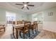 Charming dining room with wooden table, seating for six, and connections to the living room and kitchen at 549 Greenridge Ln, Loganville, GA 30052