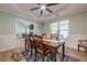 Bright dining room with wooden table, chair rail, and large windows overlooking the well maintained backyard at 549 Greenridge Ln, Loganville, GA 30052