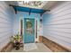 Inviting front door with a blue awning, decorated with a wreath and flowers at 549 Greenridge Ln, Loganville, GA 30052