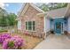 Close-up of a home's entrance with stone accents and a decorative door at 549 Greenridge Ln, Loganville, GA 30052