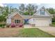 Attractive single-Gathering home with a stone facade, a two-car garage, and a manicured lawn at 549 Greenridge Ln, Loganville, GA 30052