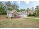 Beautiful home with a stone accent and landscaped garden for enhanced curb appeal at 549 Greenridge Ln, Loganville, GA 30052