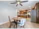 Open view of kitchen and dining area with matching wood cabinets and wood-look flooring at 549 Greenridge Ln, Loganville, GA 30052