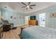 Spacious main bedroom with light blue wallpaper, ceiling fan, and ensuite bathroom at 549 Greenridge Ln, Loganville, GA 30052