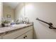 Powder room with a single sink and vanity with neutral wall color at 549 Greenridge Ln, Loganville, GA 30052