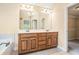 Bathroom features a double vanity and a large mirror with accent lighting at 1057 Cotton Oak Dr, Lawrenceville, GA 30045