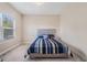 Bedroom with striped bedding and natural light at 1057 Cotton Oak Dr, Lawrenceville, GA 30045
