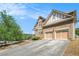 Exterior of the home featuring the garage, driveway and landscaping at 1057 Cotton Oak Dr, Lawrenceville, GA 30045