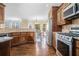 Well-lit kitchen with stainless steel appliances, granite countertops, and a breakfast area at 1057 Cotton Oak Dr, Lawrenceville, GA 30045