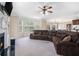Spacious living room with a fireplace, large sofa, and bay windows at 1057 Cotton Oak Dr, Lawrenceville, GA 30045