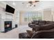 Comfortable living room with a fireplace, large sofa, and plenty of natural light at 1057 Cotton Oak Dr, Lawrenceville, GA 30045
