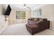 Living room with a sectional sofa, tv and window with an outdoor view at 1057 Cotton Oak Dr, Lawrenceville, GA 30045