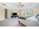 Bright main bedroom featuring an ensuite bathroom, TV, and a ceiling fan at 1057 Cotton Oak Dr, Lawrenceville, GA 30045