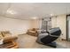 Basement sitting area with gray massage chair and beige sofas at 2118 Sableshire Se Way, Conyers, GA 30013