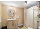 Bathroom with light tan walls and a shower with striped curtain at 2118 Sableshire Se Way, Conyers, GA 30013