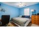 Bright bedroom with light blue walls, ceiling fan, and window at 2118 Sableshire Se Way, Conyers, GA 30013