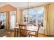 Bright dining area with hardwood floors and large windows overlooking the backyard at 2118 Sableshire Se Way, Conyers, GA 30013